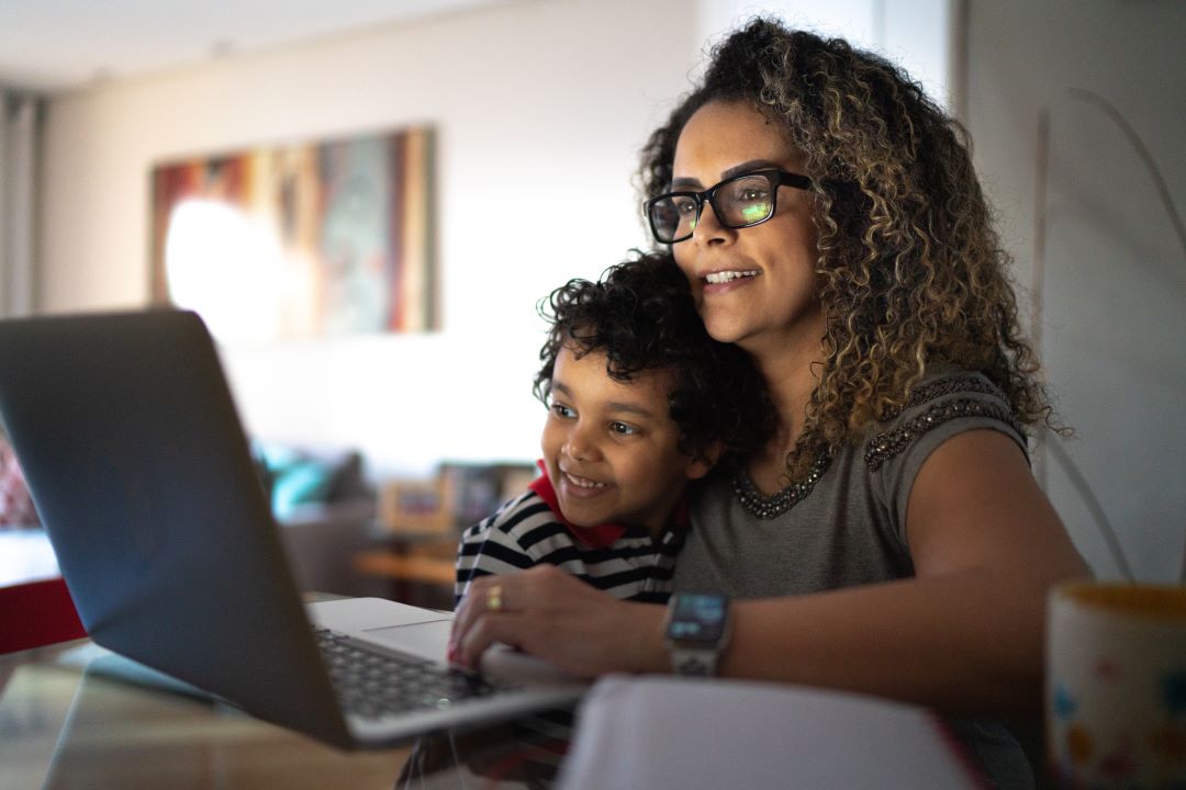 mother and child viewing laptop