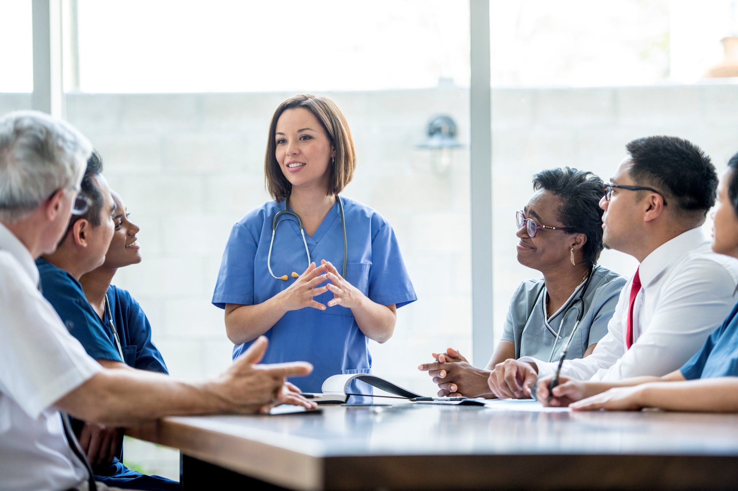 Medical professionals meeting around conference table