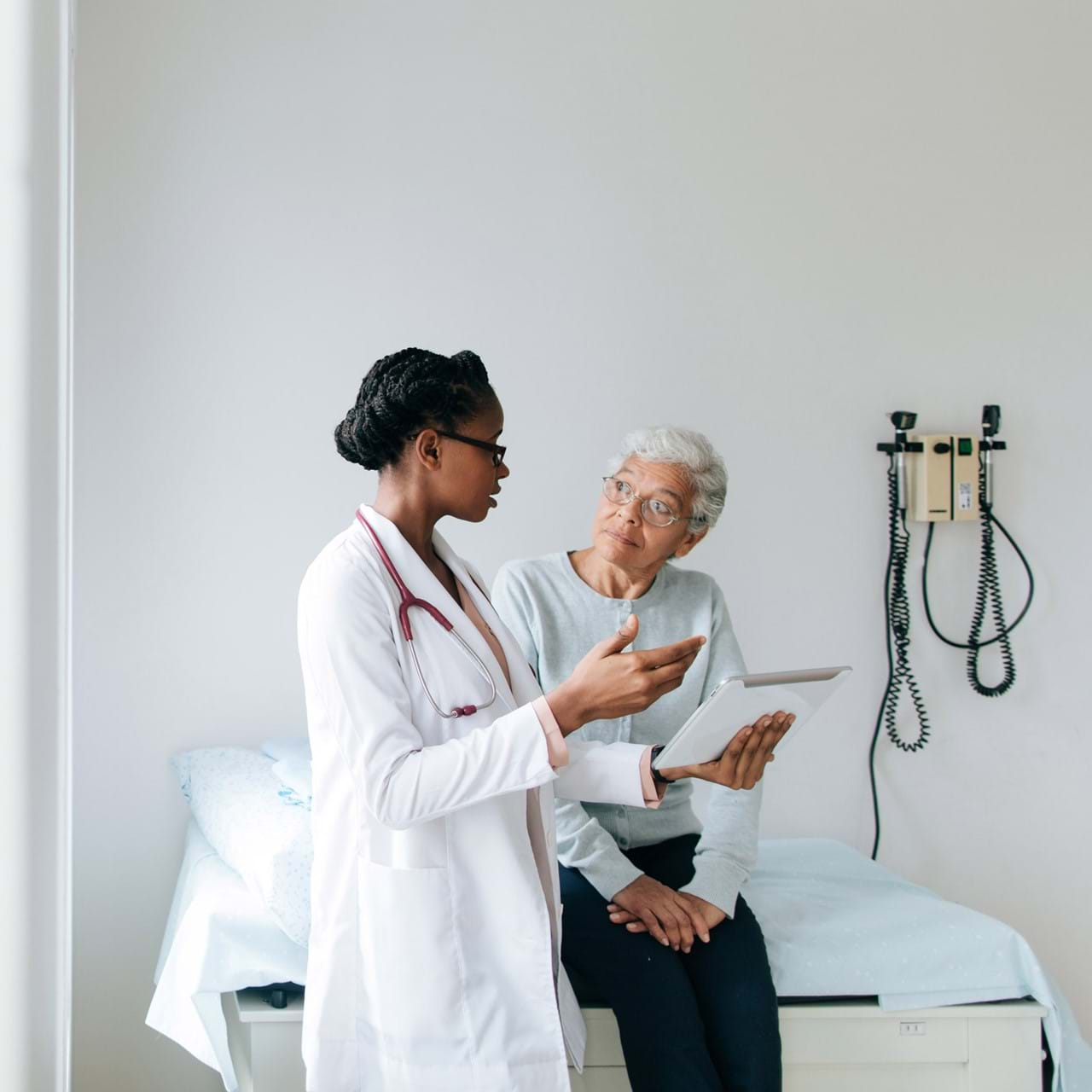 Doctor speaking to elderly patient