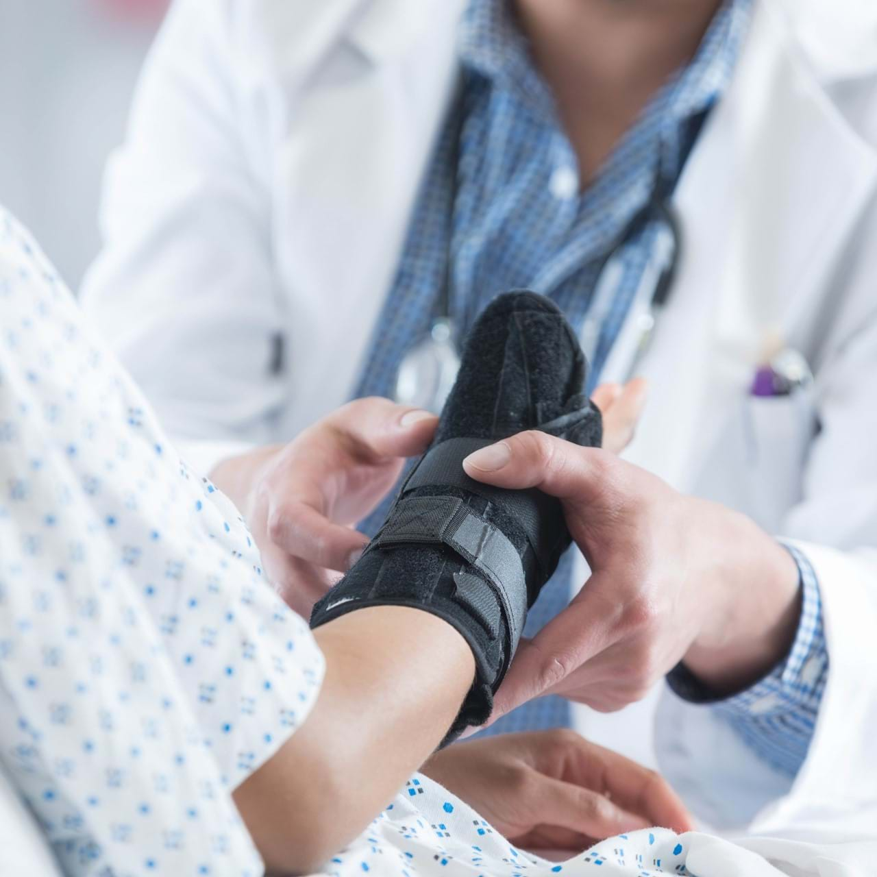 Doctor tending to patient wrist