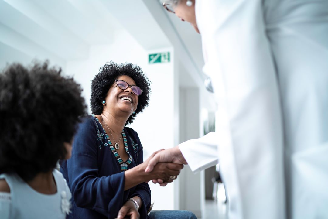 Doctor shaking woman's hand