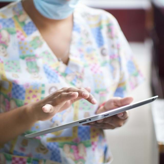 Medical staff member using a tablet